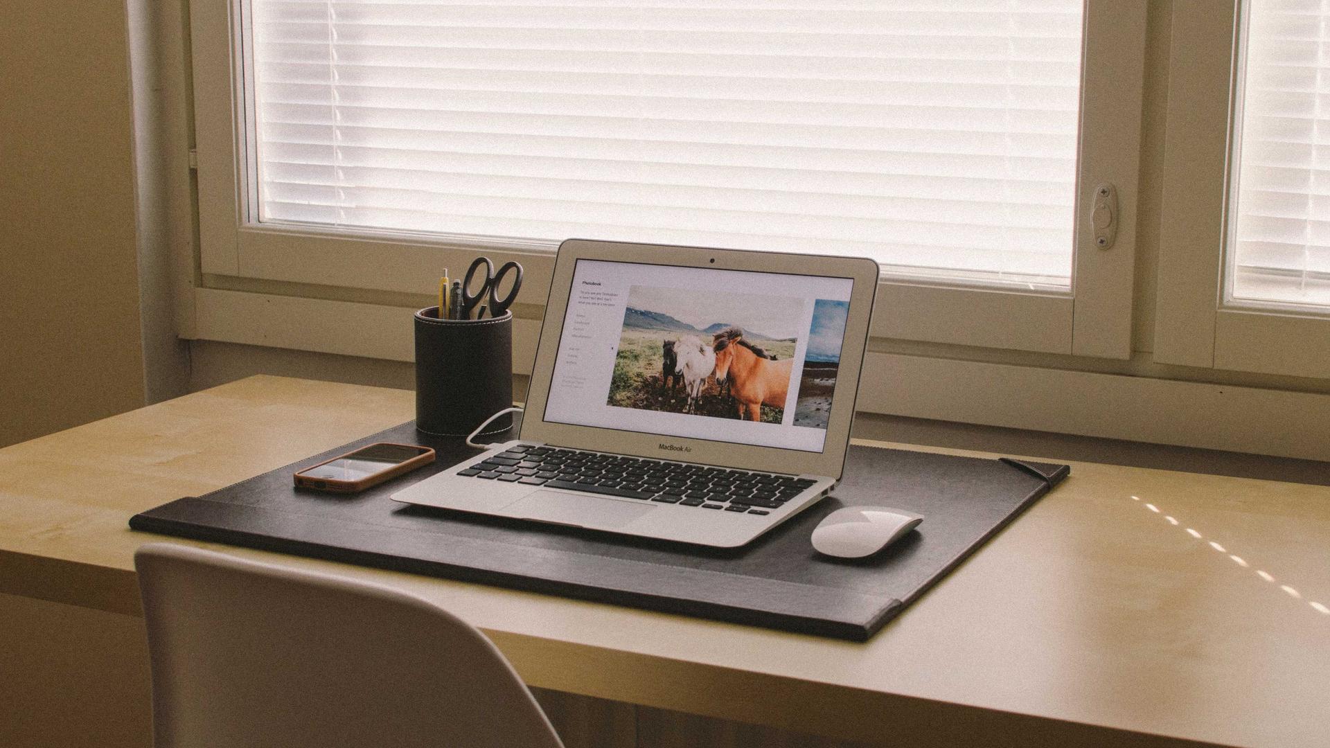 Editorial context photo of a computer workstation near a window