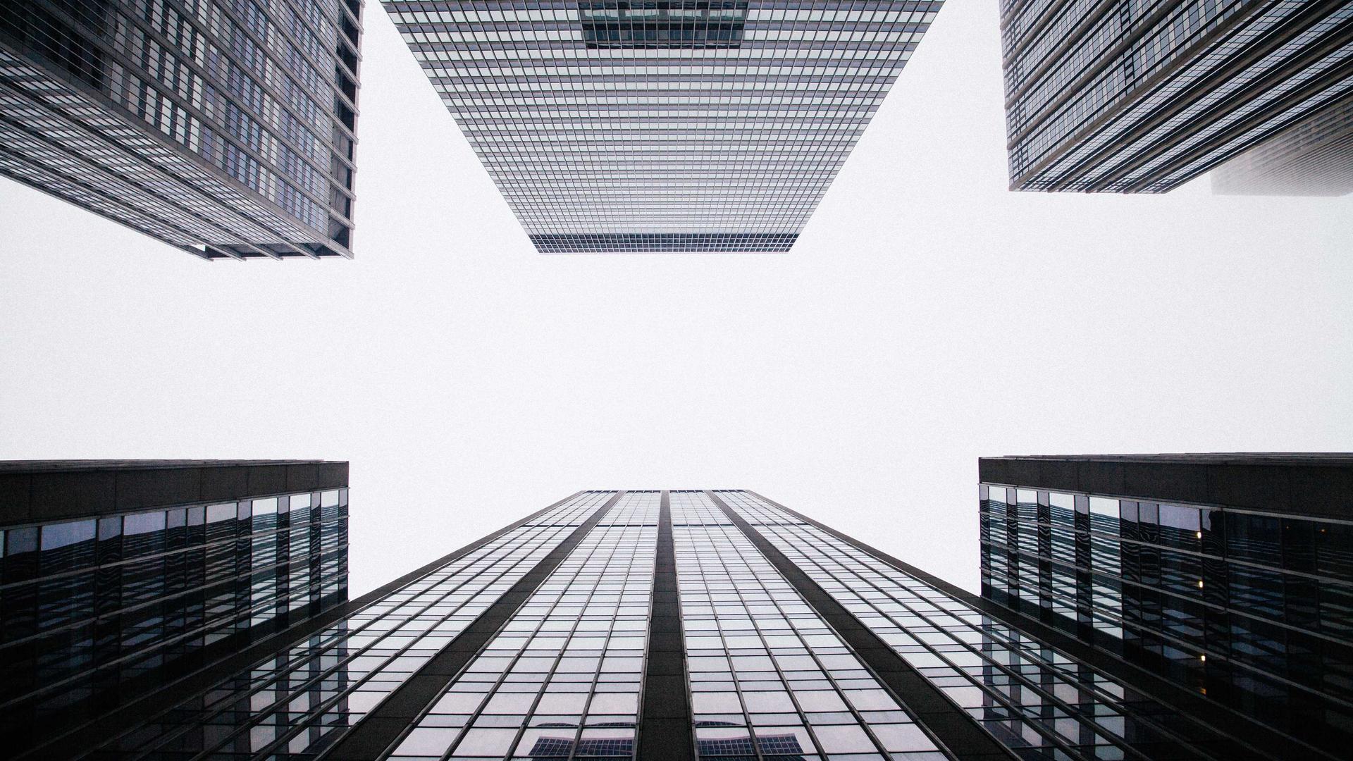 Editorial context photo looking up through a cluster of office towers