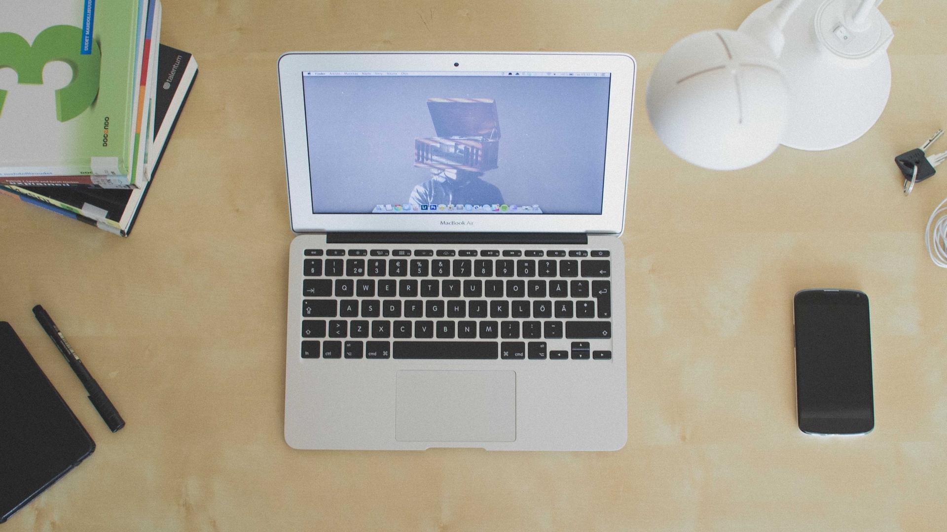 Editorial context photo of a laptop and phone on a worktable