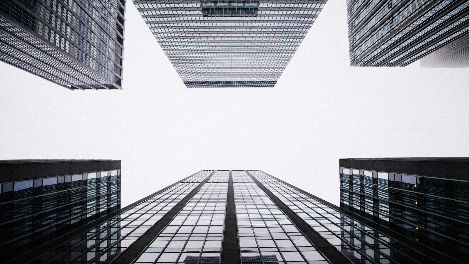 View upward between four modern office towers